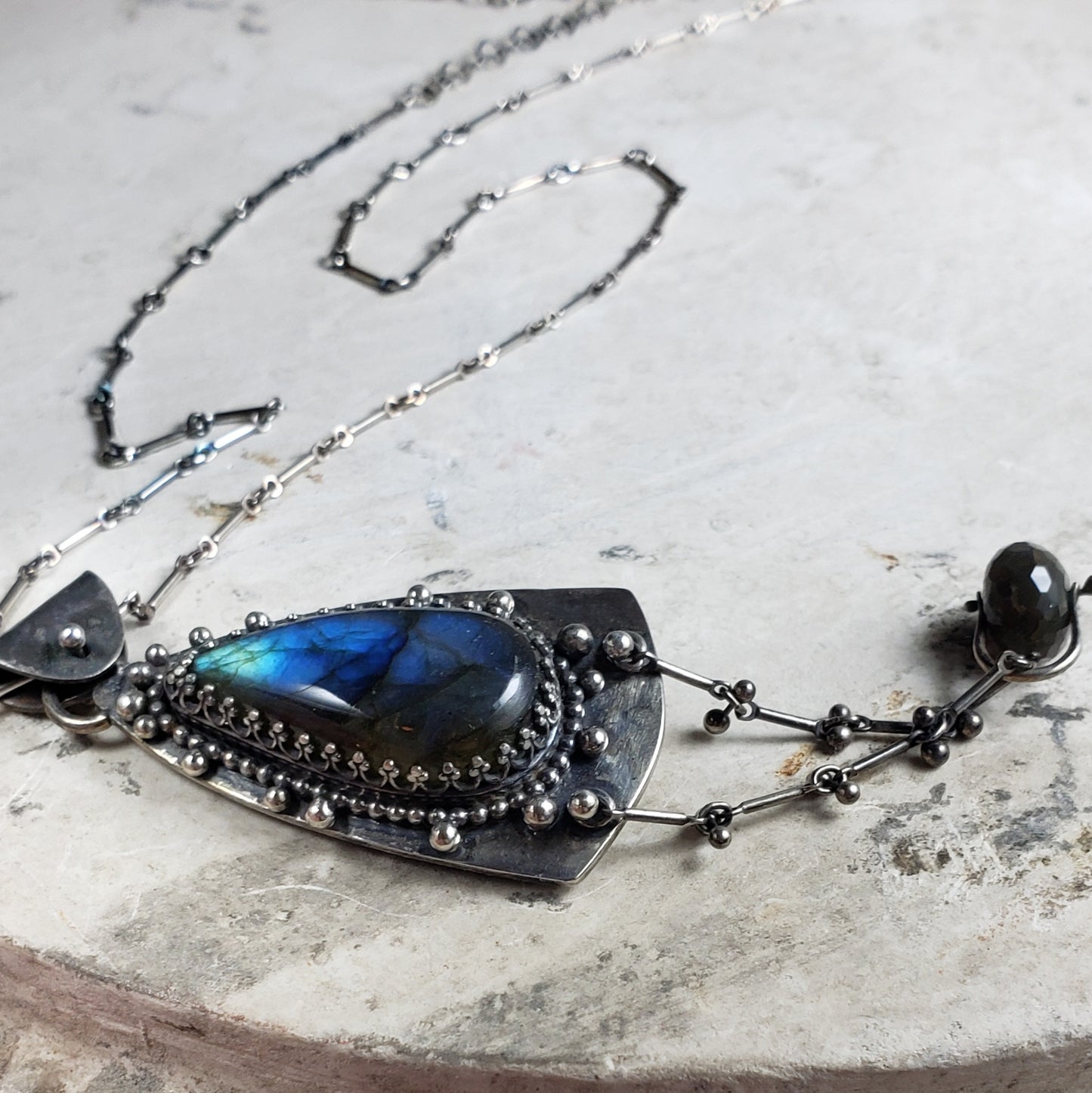 Amulet Necklace with Blue Labradorite and a Floral Embossed Backplate