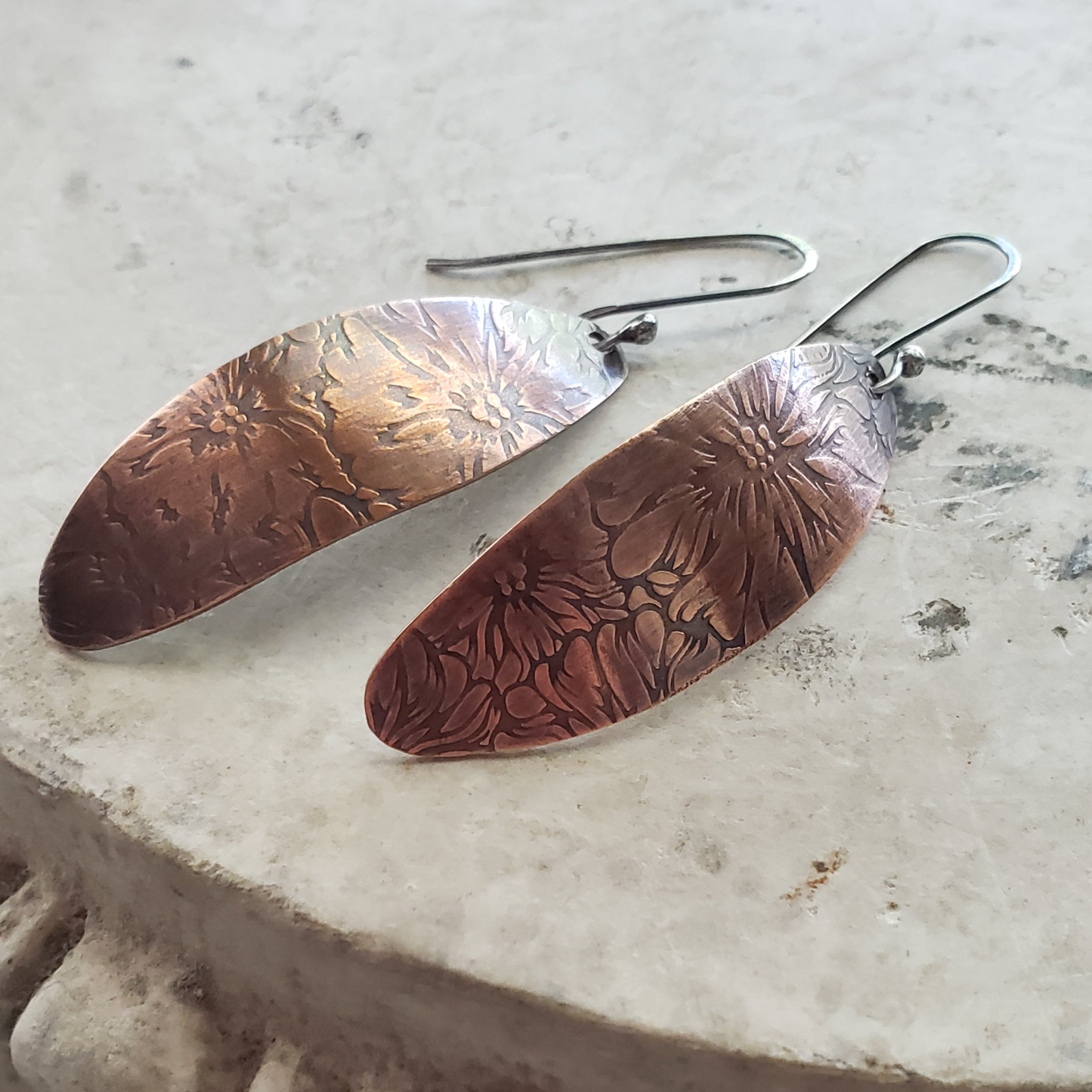 Copper dangle earrings with floral embossing