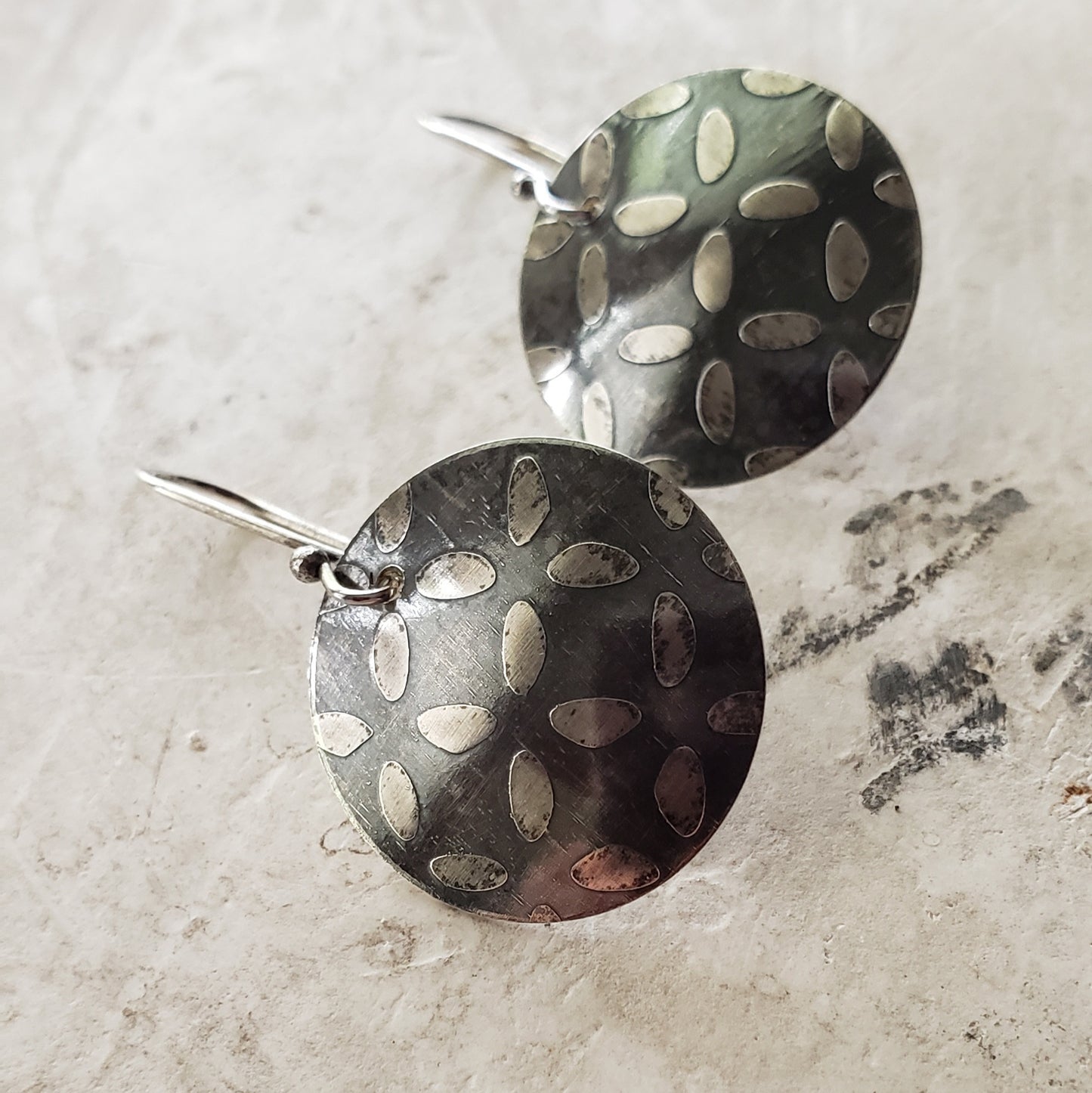 Oxidized Sterling Disc Earrings with an Etched Surface Design.