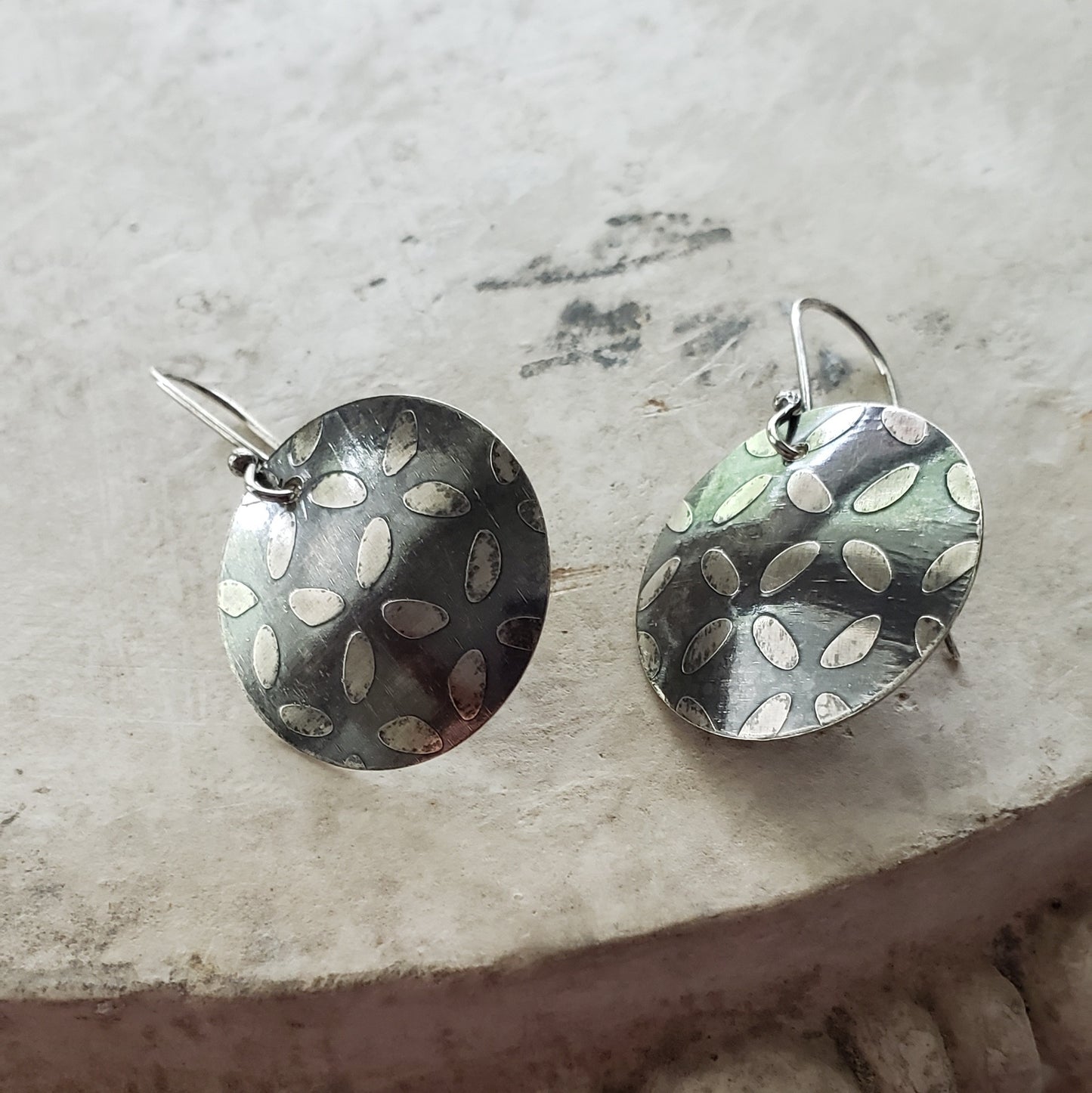 Oxidized Sterling Disc Earrings with an Etched Surface Design.