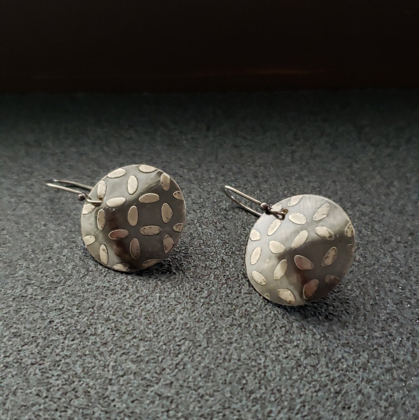 Oxidized Sterling Disc Earrings with an Etched Surface Design.