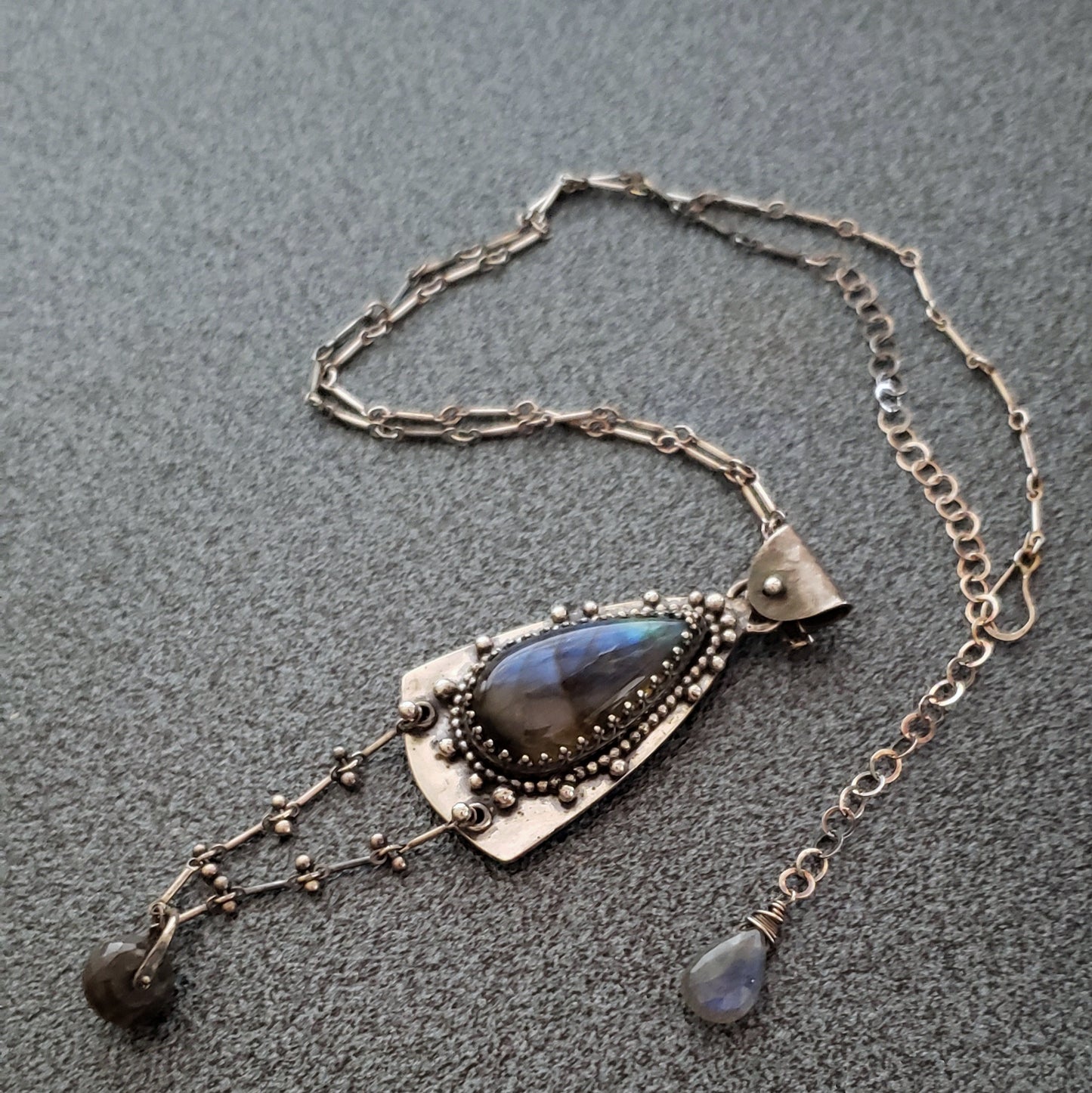 Amulet Necklace with Blue Labradorite and a Floral Embossed Backplate